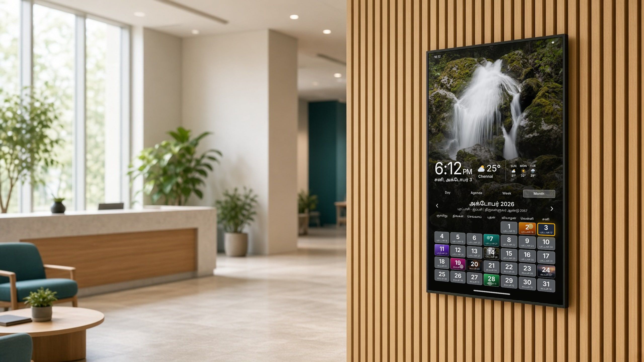 A ThiraiOne display in a bright office lobby, showing the day’s events and weather.